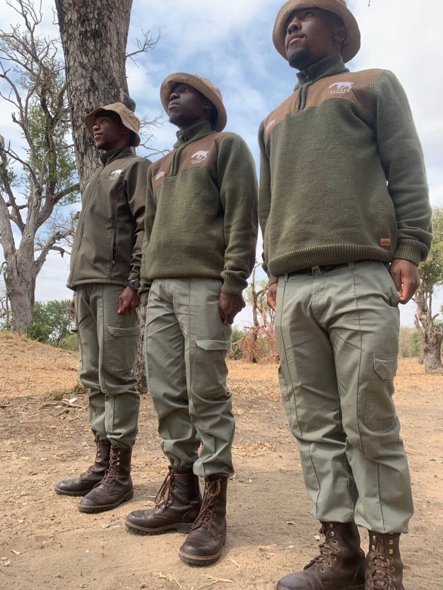 Tracker trainee identifying footprints in sandy soil