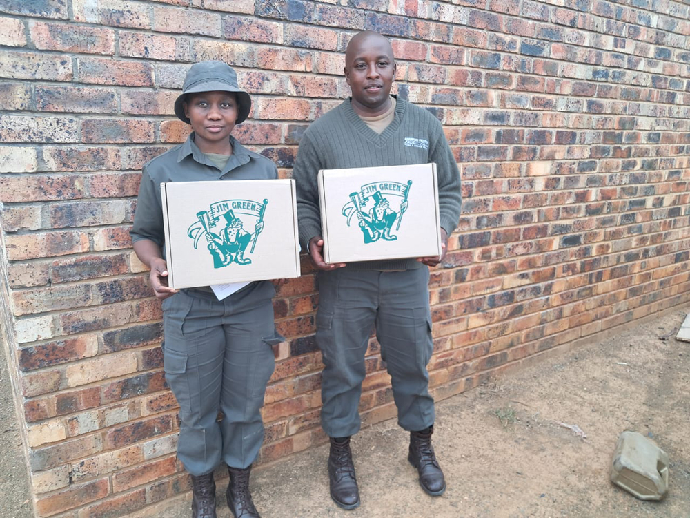 Two rangers proudly holding their new Jim Green boots